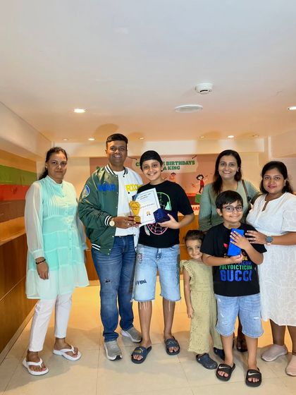 A group of proud families celebrating their children's success at the Abacus prize distribution program.