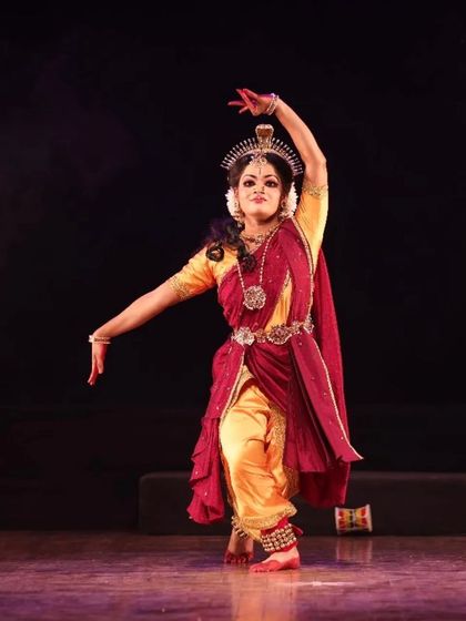 A solo performer captured in a moment of intense expression during "Shrishti Stithi Laya". The dramatic lighting and powerful posture convey the raw emotion of the story.