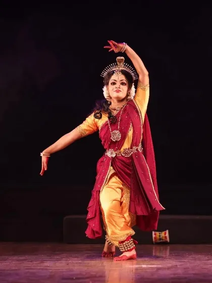 A solo performer captured in a moment of intense expression during "Shrishti Stithi Laya". The dramatic lighting and powerful posture convey the raw emotion of the story.