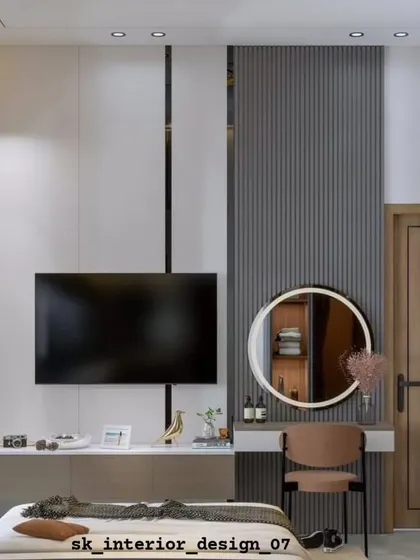 A functional and stylish bedroom wall design that integrates a TV console with a vanity table. The fluted paneling and circular mirror add a touch of modern elegance.