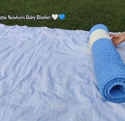Rolling up the softie newborn baby blanket, perfect for gifting.