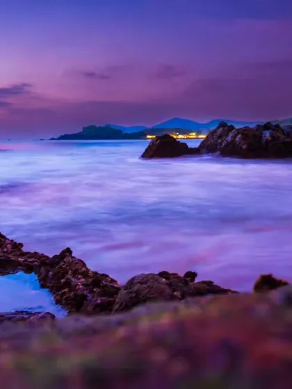 A close up view of the long exposure sunset, focusing on a small pool of water in the rocks that reflects the stunning sky. These details add depth to landscape photography.