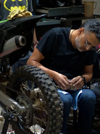 Getting my hands dirty, working on the fine details of a dirt bike in the garage. This is what we love to do, whether it's a simple tune-up or a full engine rebuild.