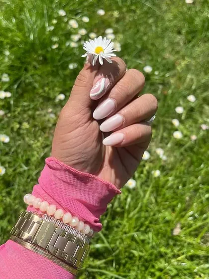 This client photo perfectly captures the simple elegance of her new manicure in a beautiful outdoor setting. A great set of nails is the perfect accessory for any day.