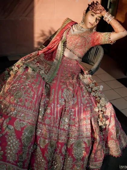We work with our brides to ensure every detail is perfect. This stunning portrait captures the bride's regal look, with dramatic lighting highlighting the intricate work on her Rimple & Harpreet Narula lehenga.