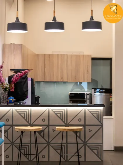 The modern kitchenette at the Brandman office is a perfect pause point. We merged a patterned tile bar front with minimalist cabinetry and pendant lighting to create a stylish and functional breakout zone.