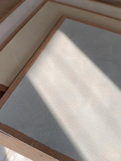 Samples of textured paint finishes soaking up the sunlight. We love playing with different materials to see how they react to light, which helps us make informed decisions for creating the perfect ambiance.
