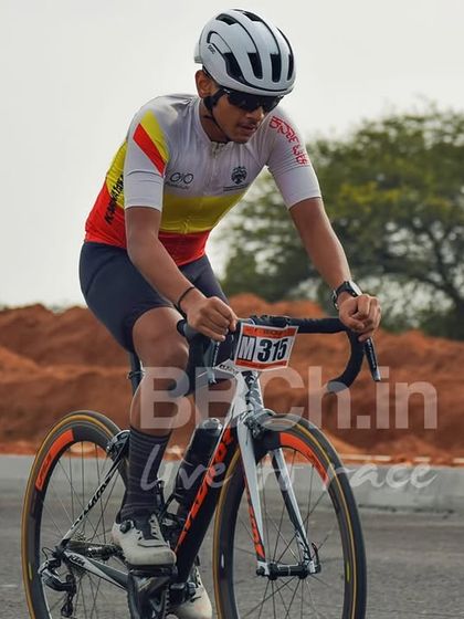 A rider in an aggressive, aerodynamic position pushes the pace. Criterium racing is all about maintaining speed through corners and on the straights.