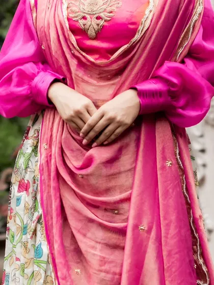 A closer look at the hand-painted Mangalagiri silk lehenga, showing the draped pink dupatta and the contemporary blouse with bishop sleeves.