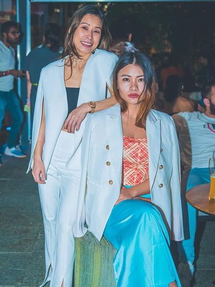 Two guests in chic white outfits.