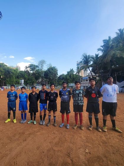 A young football team stands ready on the pitch, showcasing the diverse kits and determined faces of the players in our tournaments.