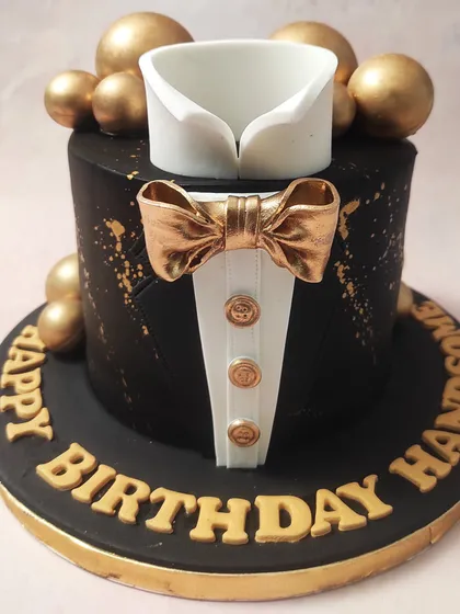 Sophistication is crafted in sugar with our black and gold Tuxedo Cake. Perfect for milestone birthdays or Father's Day, this cake features a sharp suit, a shimmering gold bow tie, and elegant gold accents, highlighting our expertise in creating refined and stylish designs for adults.