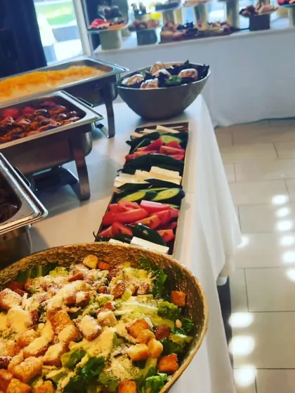Here is a look at a buffet-style service I provided, featuring a fresh Caesar salad, a platter of sliced vegetables, and hot dishes in chafing trays. I offer flexible serving styles to match the needs of your event.