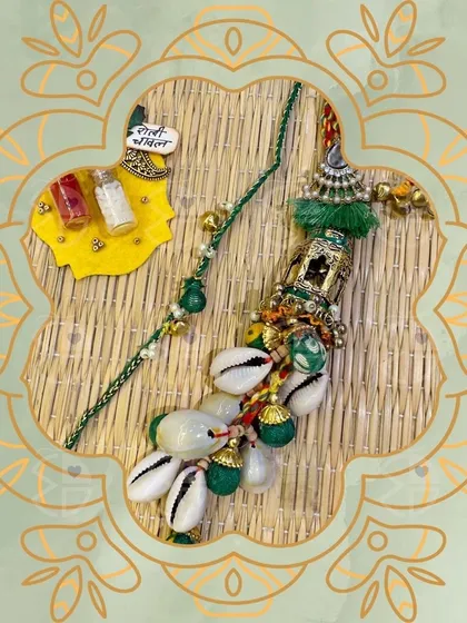 This Rakhi and Lumba set is for those who love a bohemian, traditional vibe. I've used cowrie shells and green threads to create a unique and earthy design.