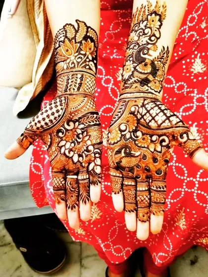 This design is a beautiful mix of floral and peacock motifs. The patterns are dense and intricate, with a good balance of bold lines and delicate shading, typical of Rajasthani mehendi.