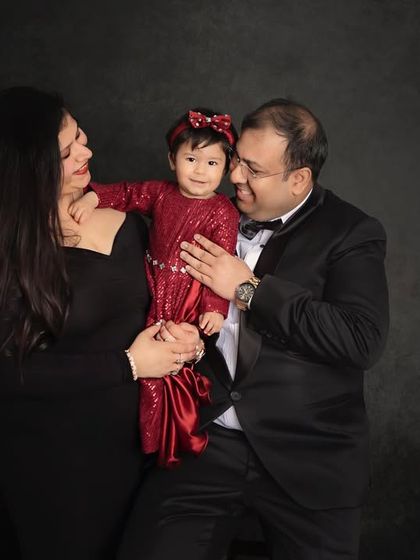 A happy family of three. The candid smiles and loving glances make this a truly special and authentic family portrait.