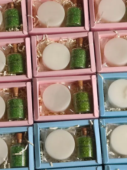 Simple and elegant return favors. These pink and blue boxes contain a plain white soap and a small bottle of green bath salts.