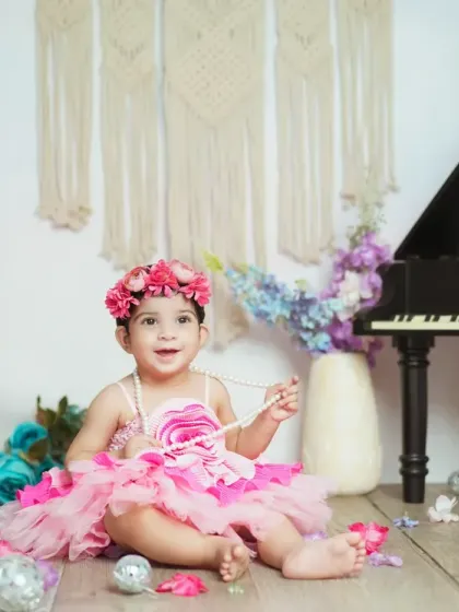 A happy smile from this little princess in her pink floral wonderland.
