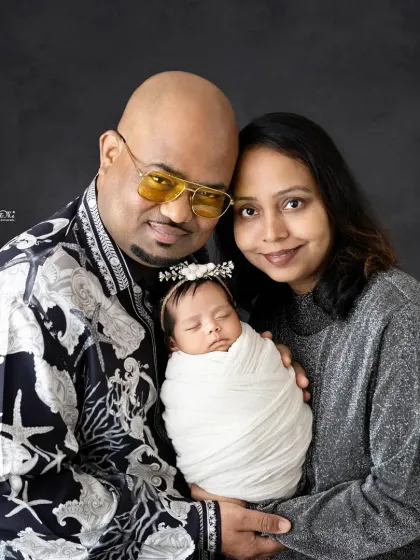 A classic portrait of mom and dad with their precious newborn. The love and pride in their expressions is what makes these photos so powerful.