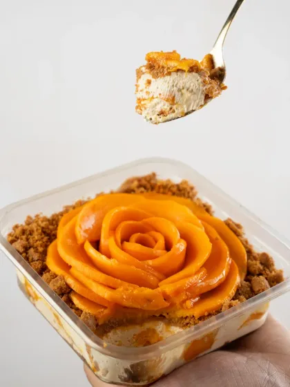 A spoonful of our Mango Biscoff Cheesecake dessert tub. It’s the perfect way to enjoy the last of the mango season.