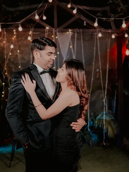 An intimate couple portrait taken under our fairy-lit gazebo. The warm string lights create a magical and romantic setting, perfect for elegant evening photoshoots.