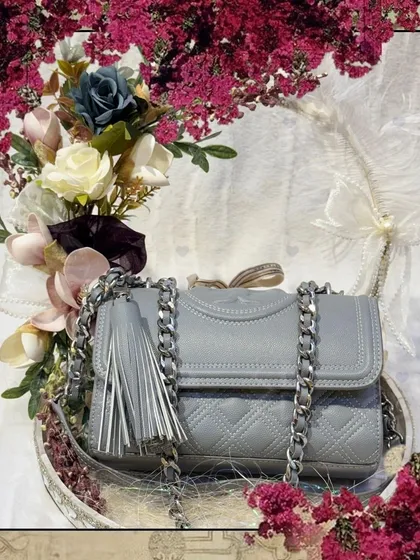 A framed version of the grey handbag, presented as a piece of art. This shows how I turn simple gifting into a memorable visual experience.