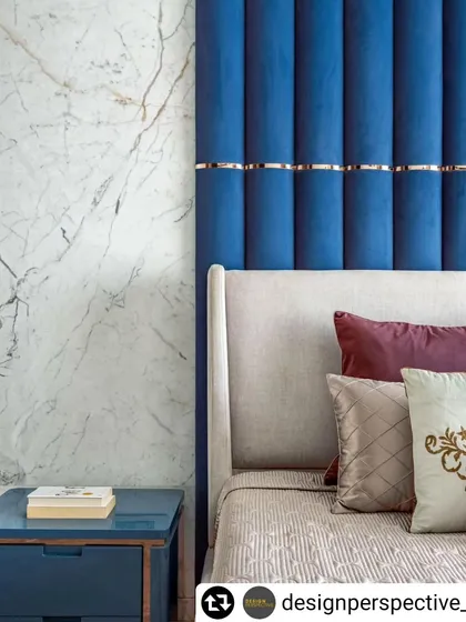Another view of the master bedroom in 'Fifty Two', highlighting the rich blue and white marble textures and the luxurious feel of the space.