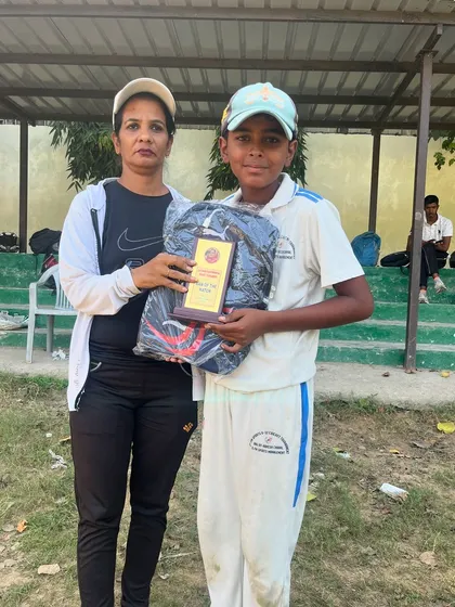 Chirag Upadhyay proudly holds his award after scoring a magnificent 100 not out.