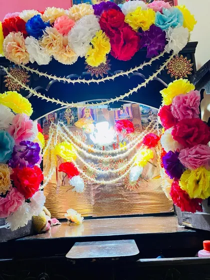 I decorate home mandirs to make them look special for any pooja or festival. This wooden mandir is decorated with colorful artificial flowers and traditional pearl strings.