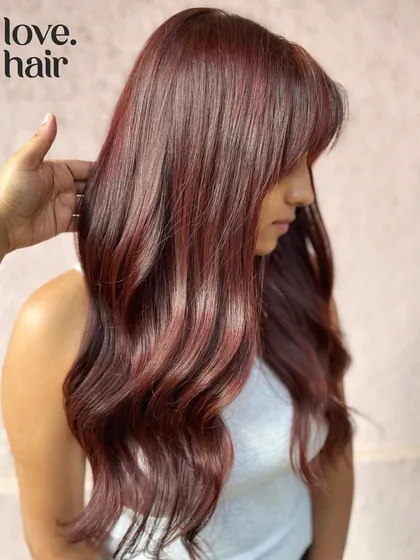 Living our Dua Lipa dreams with this cherry-cola look. We created this trending colour on long hair with a cute fringe for a result that's pure pop star.