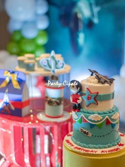 A close-up of the themed desserts for the fighter jet party. Every detail, down to the cake toppers, was designed to fit the aviation theme.