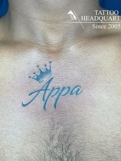 A chest tattoo of the word "Appa" (Father) with a crown on top, a sign of respect and love.
