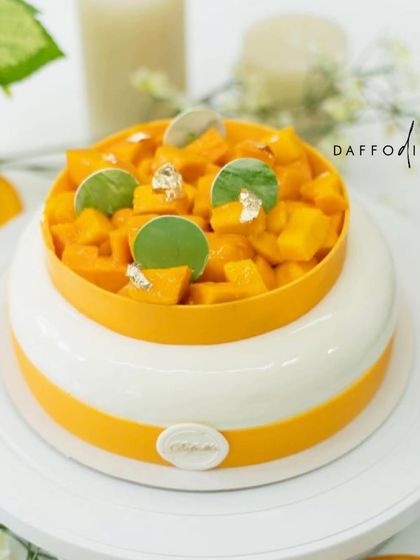 A beautiful shot of my Mango Vanilla French Entremet, topped with a generous amount of fresh diced mangoes and delicate chocolate details. This cake is a celebration of simplicity and the pure flavor of Alphonso mangoes.