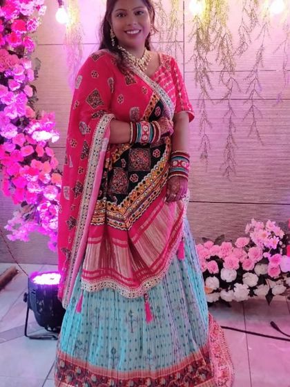 A client looking festive in a colorful printed lehenga, perfect for a mehndi or sangeet.