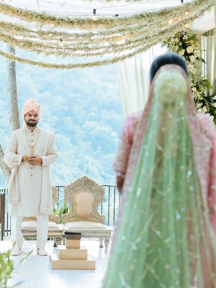 The groom's emotional first look as his bride walks towards the mandap.