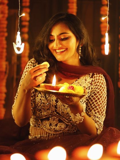 A joyful moment from the Diwali series. The model's smile and the festive makeup create a look that is full of light and happiness.