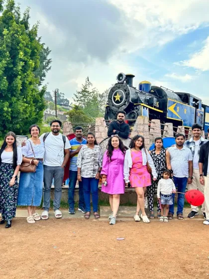 A group posing in front of the iconic toy train in Ooty. This is a must-do activity and a perfect photo opportunity on our Ooty weekend trip.