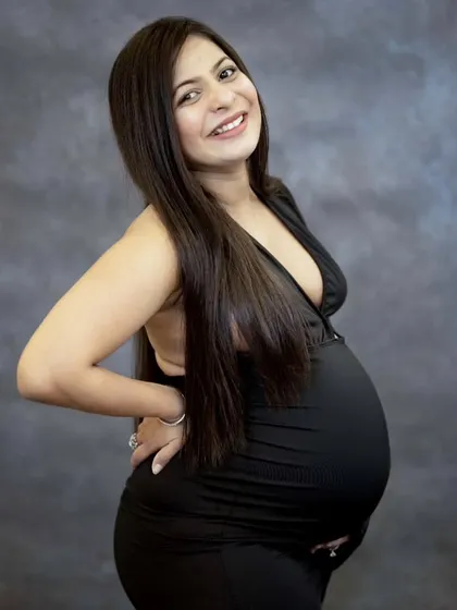 A classic portrait is always a beautiful choice. With a simple backdrop and professional lighting, we can focus entirely on your happy glow. This momma-to-be's radiant smile says it all.