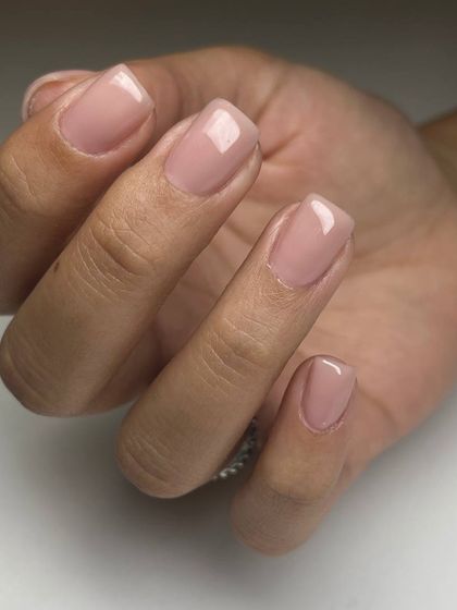 A classic nude pink overlay on short, square nails. This service strengthens the natural nail while providing a perfectly polished and professional appearance.