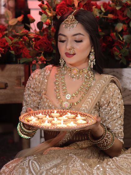 Another shot from our Diwali creative shoot. The warm lighting from the diyas adds a beautiful glow to her skin, enhancing the radiant makeup look.