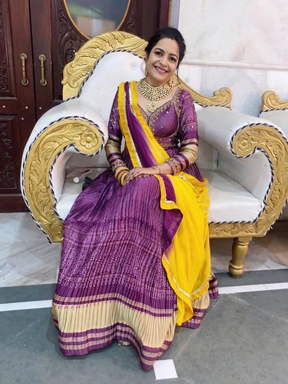 This purple and yellow bandhani lehenga is a classic and graceful choice for wedding festivities. The traditional print and rich colours make it a timeless piece that is always in style.