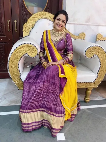This purple and yellow bandhani lehenga is a classic and graceful choice for wedding festivities. The traditional print and rich colours make it a timeless piece that is always in style.