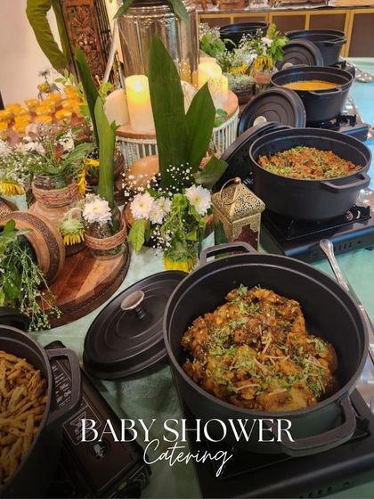 A closer look at our baby shower catering. We use fresh flowers and rustic decor to create a warm and inviting atmosphere, with delicious main courses served in stylish cast iron pots.