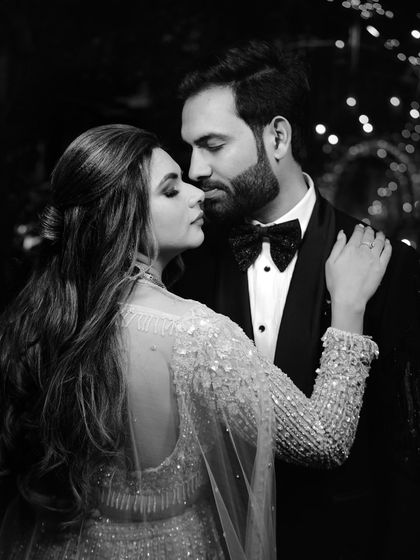 An intimate black and white close-up of the couple. This classic, romantic portrait focuses on their connection and the elegant details of their attire.