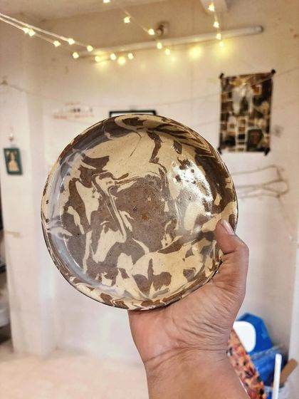 This beautiful marbled bowl was made by Ashna in her beginner's course. She explored the Nerikomi technique, mixing two different clays to create these organic swirls.