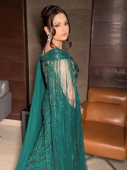 A side view of the Hollywood glam look. The sharp, winged liner elongates the eye, and the subtle green shimmer adds a touch of unexpected color.