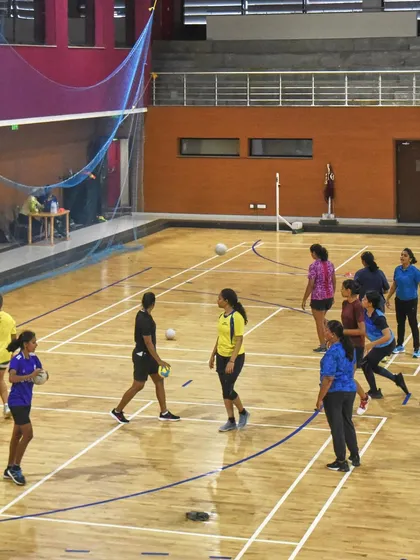 A wide view of the court during the women's team practice. This shot gives a sense of the space and positioning involved in a typical training session.