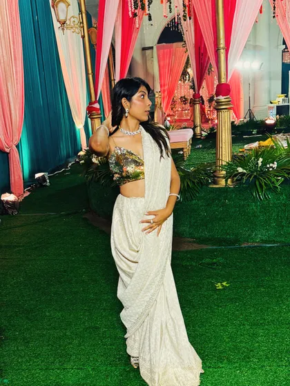 This is one of my favorite looks, a custom-draped saree with a gold sequin blouse that I designed and created from scratch. It's perfect for a cocktail party or a wedding reception. I love helping clients bring their unique vision to life, whether it's for a single event or their entire wedding.