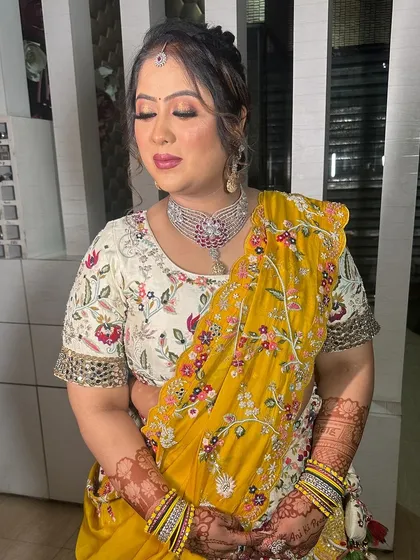 Getting her ready for her brother's wedding. This look is festive and colorful, with a beautiful yellow dupatta and a radiant makeup finish.