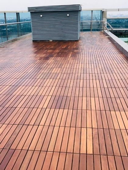 Another perspective of the rooftop deck, showing how the linear pattern of the IPE wood planks creates a sense of depth and space.